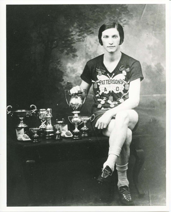 Bobbie Rosenfeld posing with her trophies.