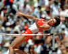 Debbie Brill attempts to jump over a bar.