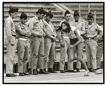 Debbie Van Kiekebelt running past soldiers