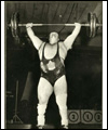 Doug Hepburn lifts weights over his head in competition