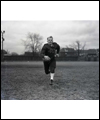 Fritz Hanson on the football field carrying the football