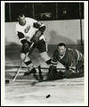 Gordie Howe (left) with goaltender Johnny Bower on the ice