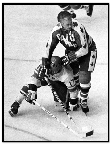 Gordie Howe holds down an opposing player