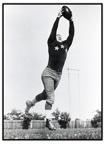 Hugh Stirling raises his arms in the air to catch a football