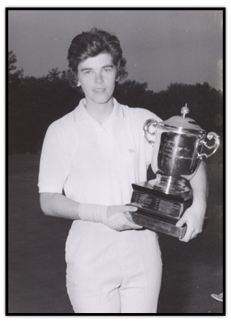 Jocelyne Bourassa  with a golf trophy