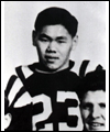 Normie Kwong in a football uniform wearing number 23