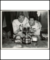 Jackie Parker and Normie Kwong (right) celebrating with the Grey Cup