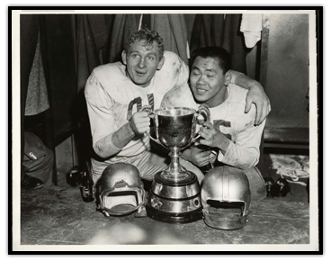 Jackie Parker and Normie Kwong (right) celebrating with the Grey Cup