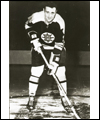 Phil Esposito in his Boston Bruins uniform holding his stick