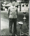 Charles (Sandy) Somerville stands beside his U.S. Amateur Golf trophy