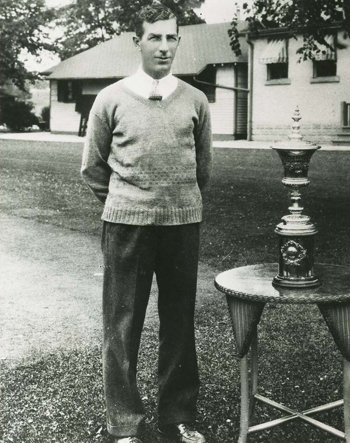 Sandy Somerville posing with golf trophy.